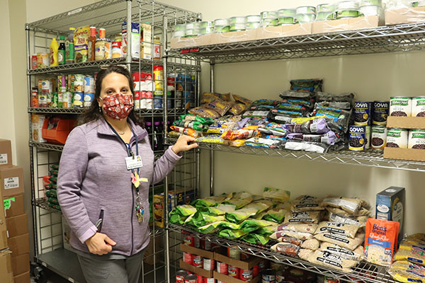 Nurse Practitioner Lynne Rudderow  inside the food pantry at Chester County Hospital's OBGYN Clinic.